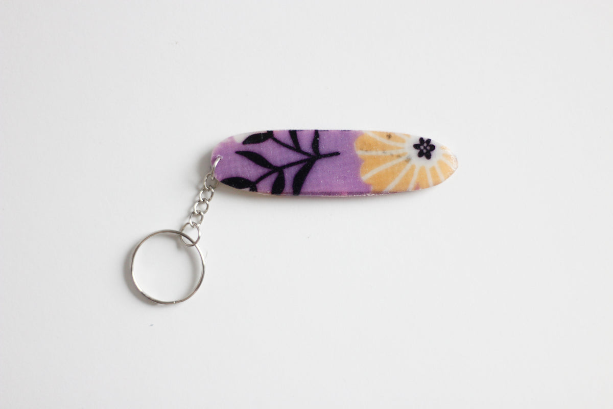 Surf shaped purple key chain