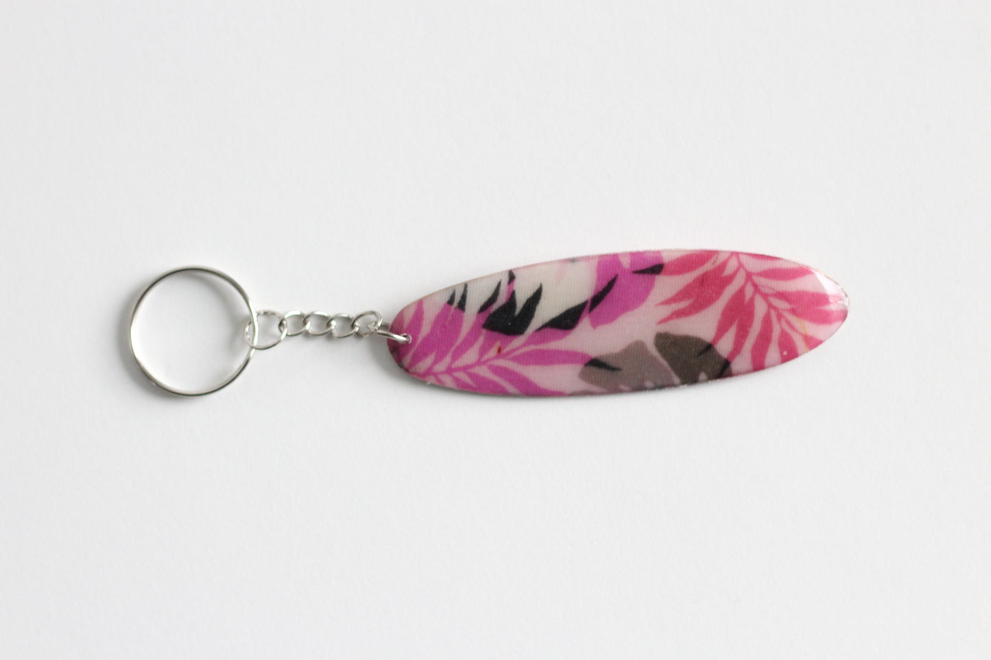 Surf shaped pink monstera key chain