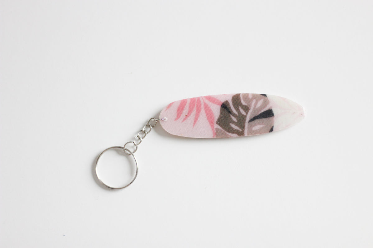 Surf shaped pink monstera key chain